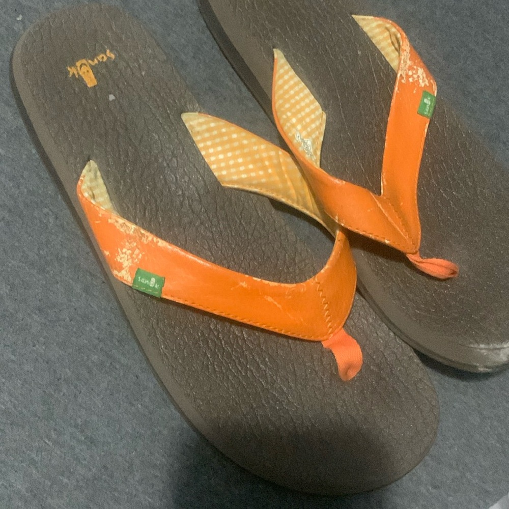 Orange and brown flip flops